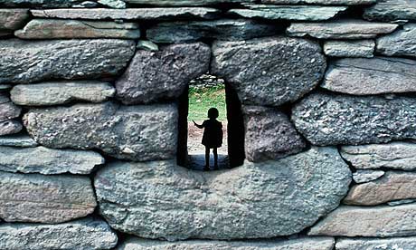 Child in the portal of the Gallarus Oratory in County Kerry, Ireland